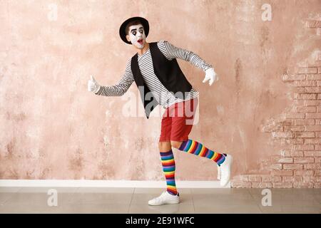 Male pantomimist on color background Stock Photo