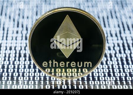 Ethereum physical coin close-up view on binary code Stock Photo