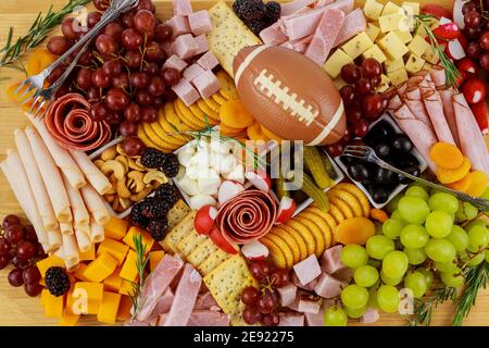 Charcuterie board with cheese, grape, ham and crackers. American football meal. Stock Photo