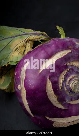 One purple kohlrabi on a black background Still life Dark food photography Stock Photo