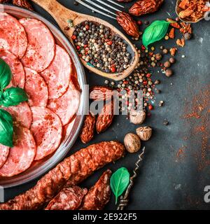 Various snack sausages and sliced salami in plate Stock Photo