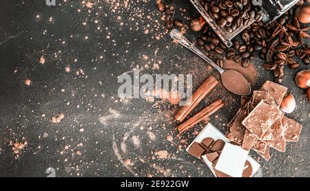 Chocolate, nuts, spices on a smooth black table Stock Photo