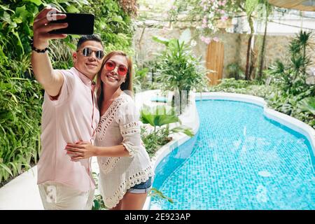 Couple hugging and taking selfie Stock Photo