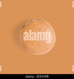 Macaron. Traditional french colorful macarons close up, macro isolated on orange background Stock Photo
