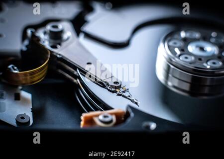Closeup of head of hard disk drive on dark background Stock Photo