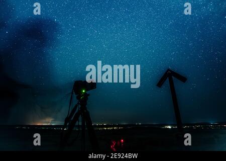 Taking photo of night sky strewn with stars Stock Photo