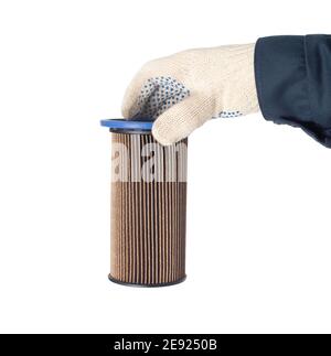 An auto mechanic holds an old dirty fuel filter in his hand. Fuel filter replacement concept, low-quality fuel, white background, isolate, equipment Stock Photo