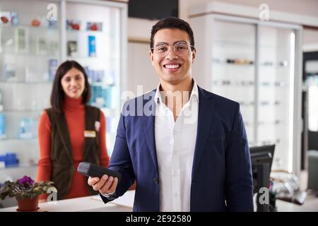 High-spirited customer holding a spectacle case in one hand Stock Photo
