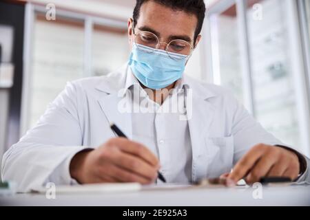 Focused eye doctor working in his office Stock Photo