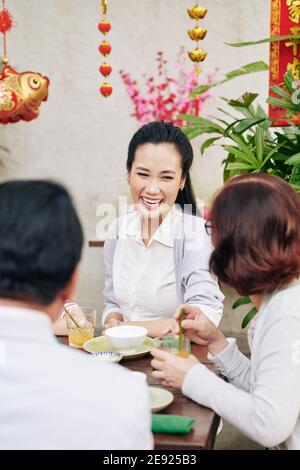 Woman celebrating Chinese New Year with family Stock Photo