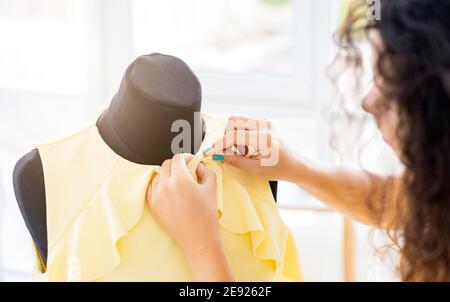 Close up view of hands sewing with needle Stock Photo
