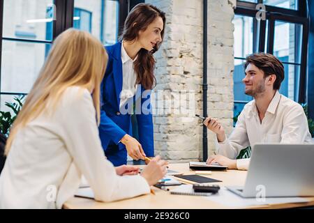 Businesswoman showing on tablet to colleagues Stock Photo