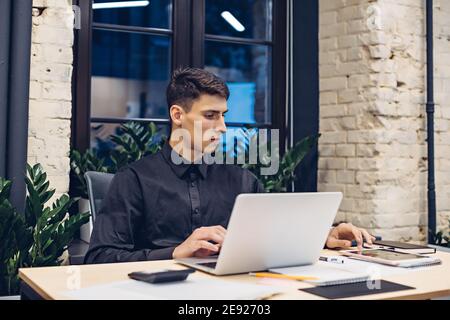 Businessman working on laptop and using tablet Stock Photo