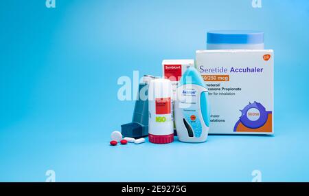 CHONBURI, THAILAND-JANUARY 31, 2021 : Symbicort, Avamys, Seretide, Ventolin, with tablets pills and bottle on blue background. Asthma and COPD inhaler Stock Photo