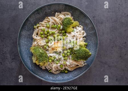 healthy baked green spaghetti pasta with feta cheese Stock Photo