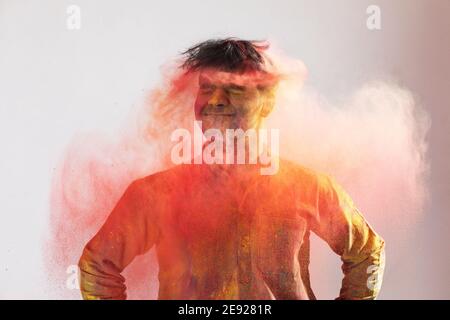 Young man shaking his head full of colors Stock Photo