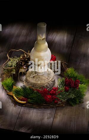 Old handmade lamp and christmas garland on an old wooden background Stock Photo