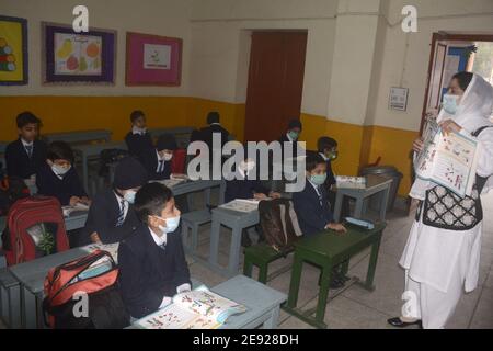 Pakistani students in classroom with masks, emphasizing health safety