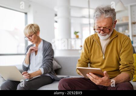 Senior couple having problems with technology devices at home Stock Photo