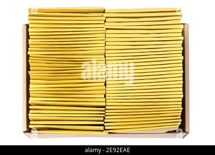 Top view of two rows of padded bubble envelopes in a kraft cardboard box isolated on white. Stock Photo