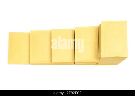 Top view of five stacks of yellow mail envelopes arranged in line in descending order imitating stairs isolated on white Stock Photo