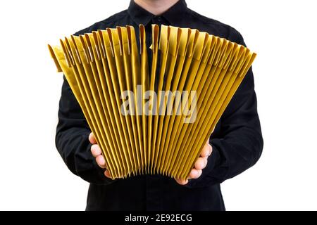 Man in black uniform holding a stack of yellow bubble envelopes isolated on white Stock Photo