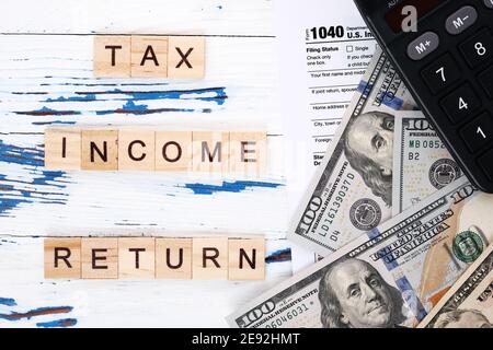 Personal income tax form 1040, dollar bills and calculator.  Stock Photo