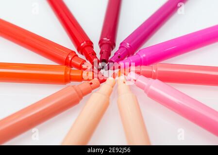 Close up of red colored felt-tip pens on isolated background. Selective focus. Different shades of red Stock Photo