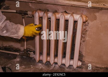 coloring spraying battery radiator heater restoration protective mask and suit Stock Photo