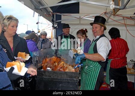 A Butcher serves hog roast to visitors at the Worcester Victorian Christmas Market, December 2007 Stock Photo