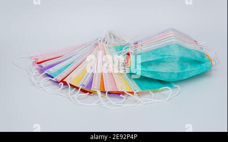 colored medical masks on a white background. sterile bandages on the face to protect against viruses and infections Stock Photo
