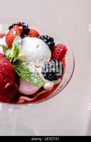 Ice cream serving in a glassware with different berries Stock Photo