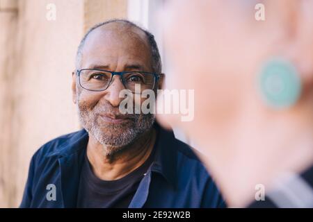Smiling senior man in balcony Stock Photo