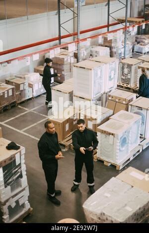 High angle view of manual workers working in logistics warehouse Stock Photo