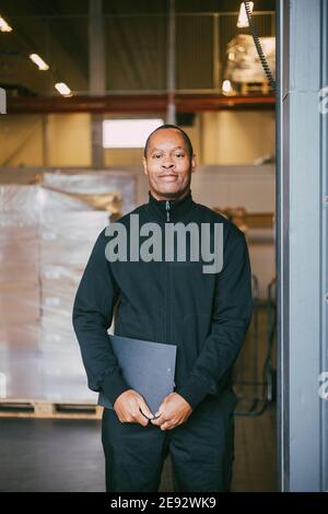 Portrait of smiling male manual worker at warehouse Stock Photo