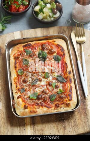 Homemade pizza with tomato sauce and cheese Stock Photo