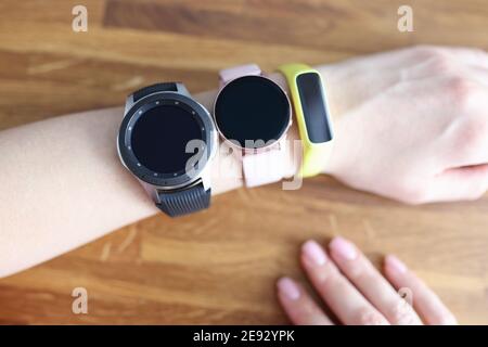 Three different wristwatches are wornning on womans hand closeup Stock Photo