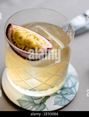 Old fashioned cocktail with a twist with passion fruit Stock Photo