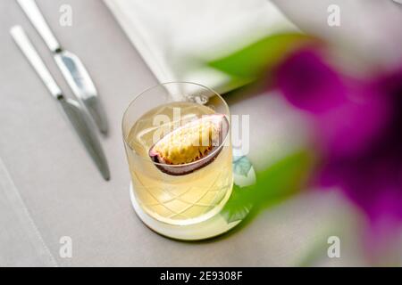 Old fashioned cocktail with a twist with passion fruit Stock Photo