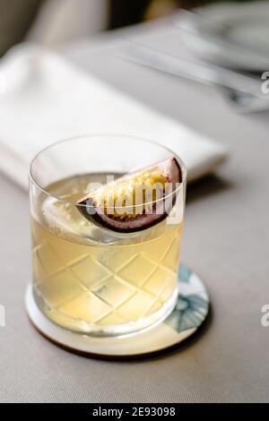 Old fashioned cocktail with a twist with passion fruit Stock Photo