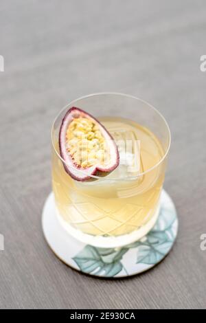 Old fashioned cocktail with a twist with passion fruit Stock Photo