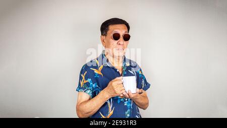 Cool senior Asian man drinking coffee Stock Photo