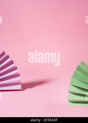 Geometrical pink background with paper colorful fans Stock Photo
