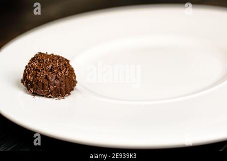Chocolate truffle, single, on a plate at a restaurant Stock Photo