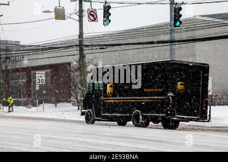 NORWALK, CT, USA-FEBRUARY 1, 2021:  UPS truck delivery during snow day on Connecticut Ave. Stock Photo