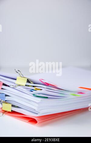 Close-up of a set of sheets attached by clips and clamps. Vertical photography. Information overload concept Stock Photo