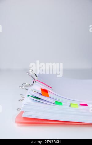 Close-up of a set of sheets attached by clips and clamps. Vertical photography. Information overload concept Stock Photo