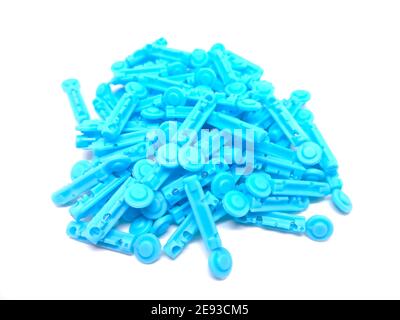 Closeup shot of a heap of disposable sterile lancets isolated on a white background Stock Photo