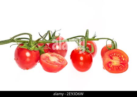 Cherry tomatoes isolated on white background with a tomato cut in half Stock Photo