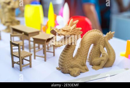 3D printer printing dragon head figure close-up. Stock Photo